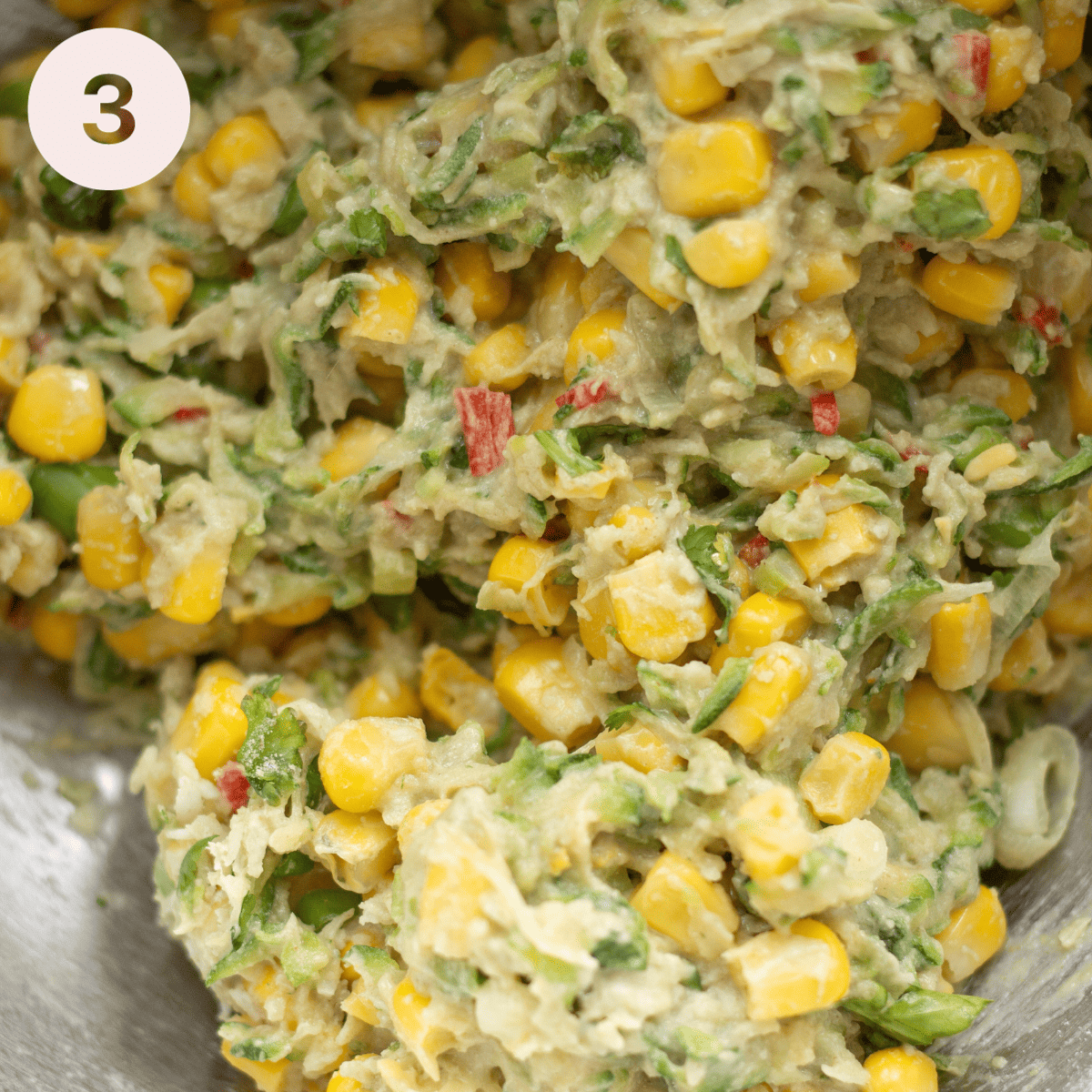 Mixing all the ingredients together for the zucchini fritters.