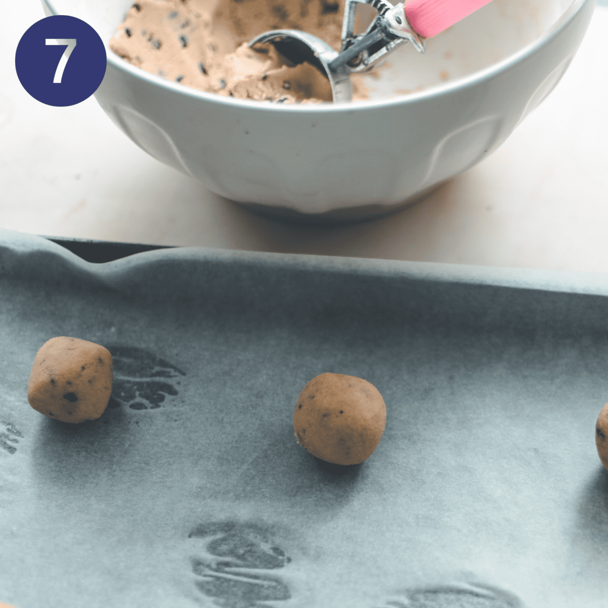 Putting balls of cookie dough on a baking tray.