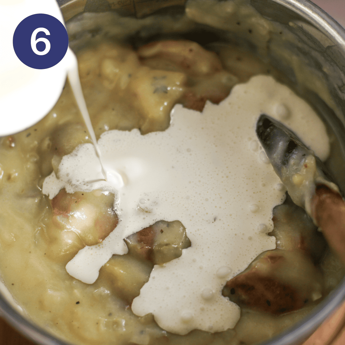 Adding cream to baked potato soup.
