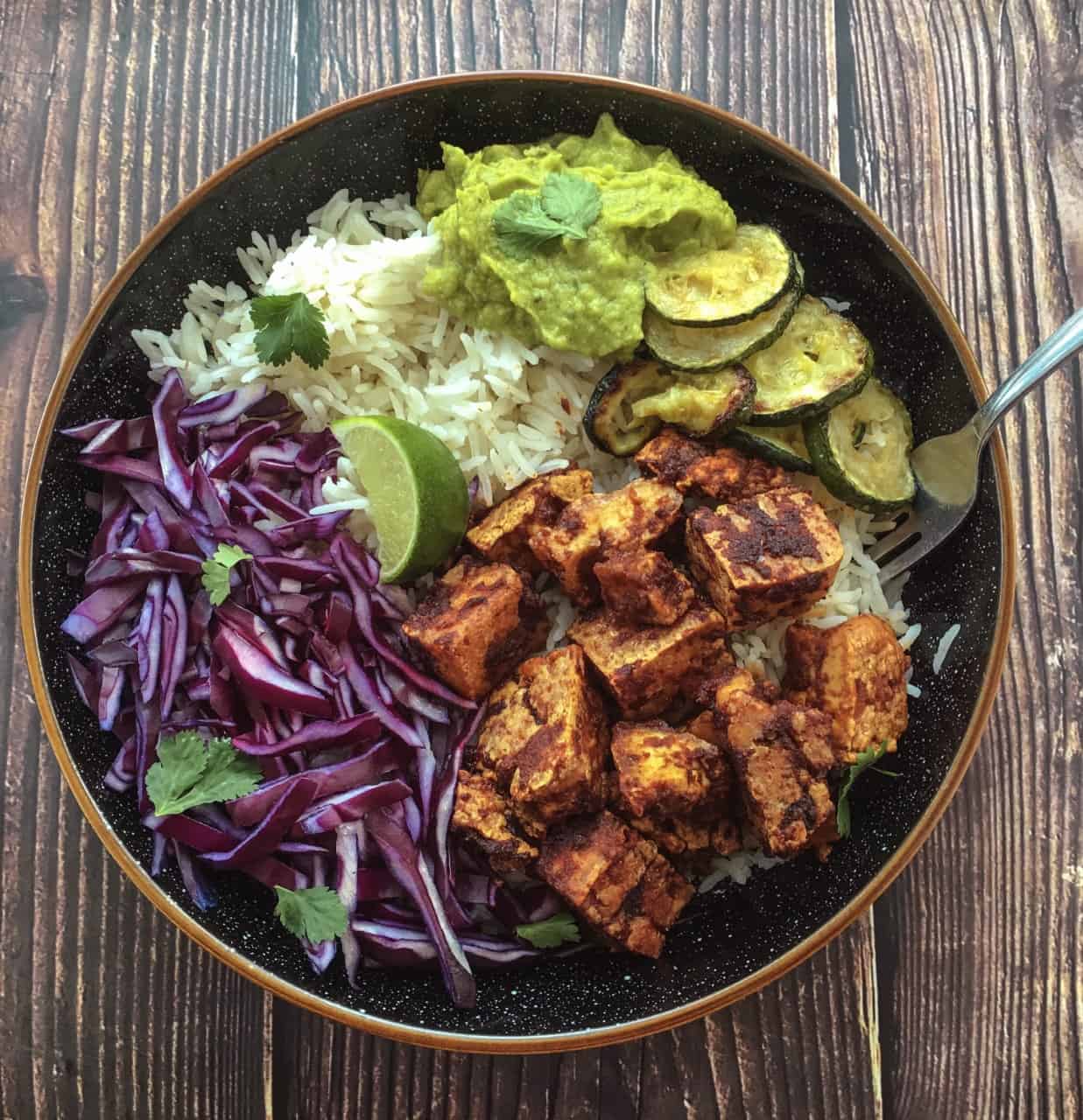 Tofu Bowl with lots of fried veg and red cabbage