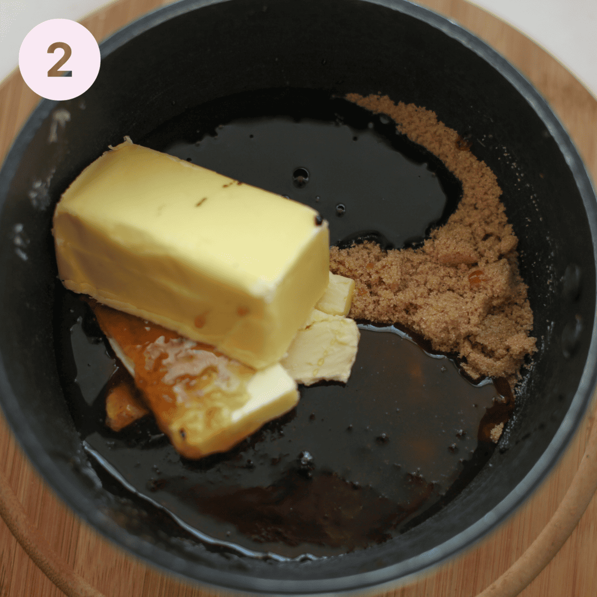 Melting butter and sugar together in a saucepan.