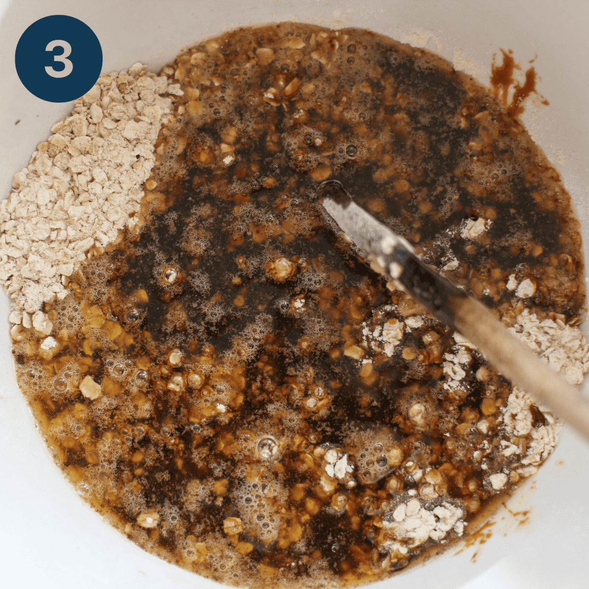 Adding the melted butter and sugar to the oatmeal mixture.