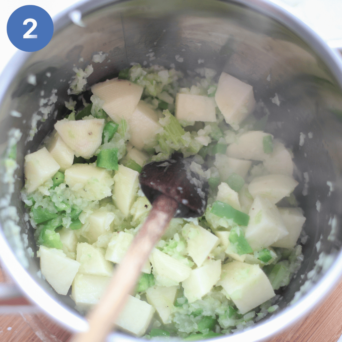 Adding diced potatoes to sauteed onion.