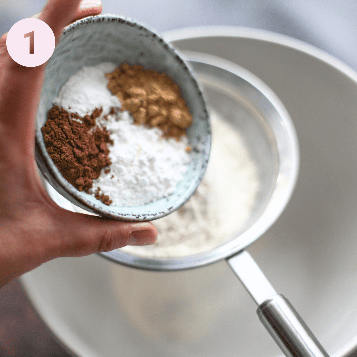 Sifting flour and spices into a bowl.