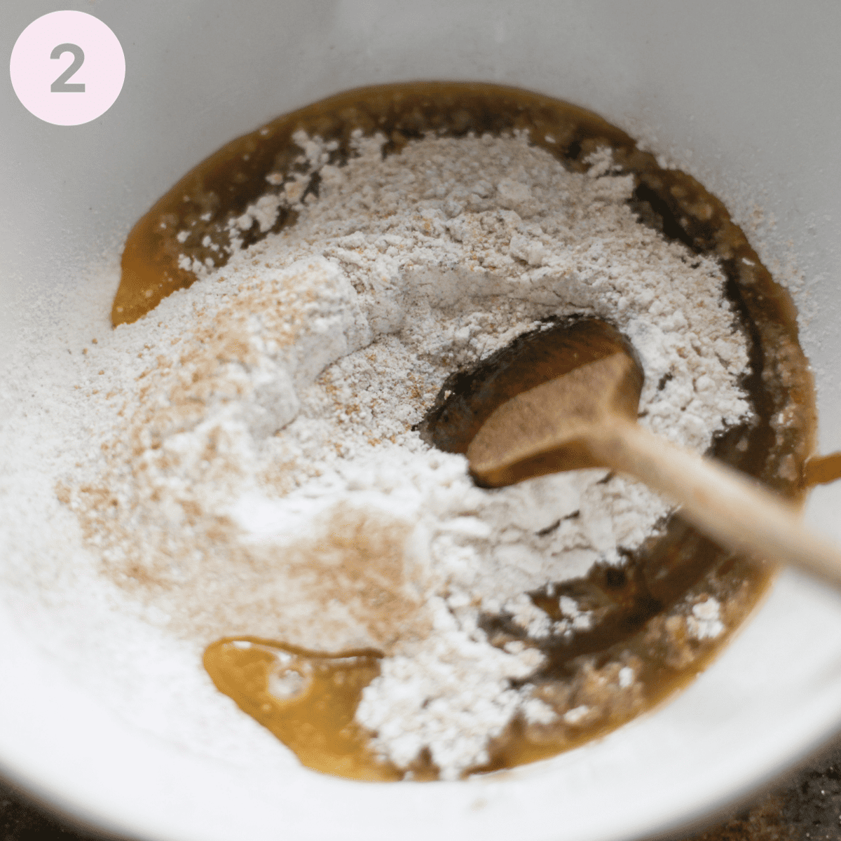 Mixing wet ingredients into flour.