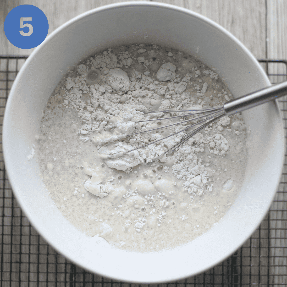 Adding the soured milk to the flour.