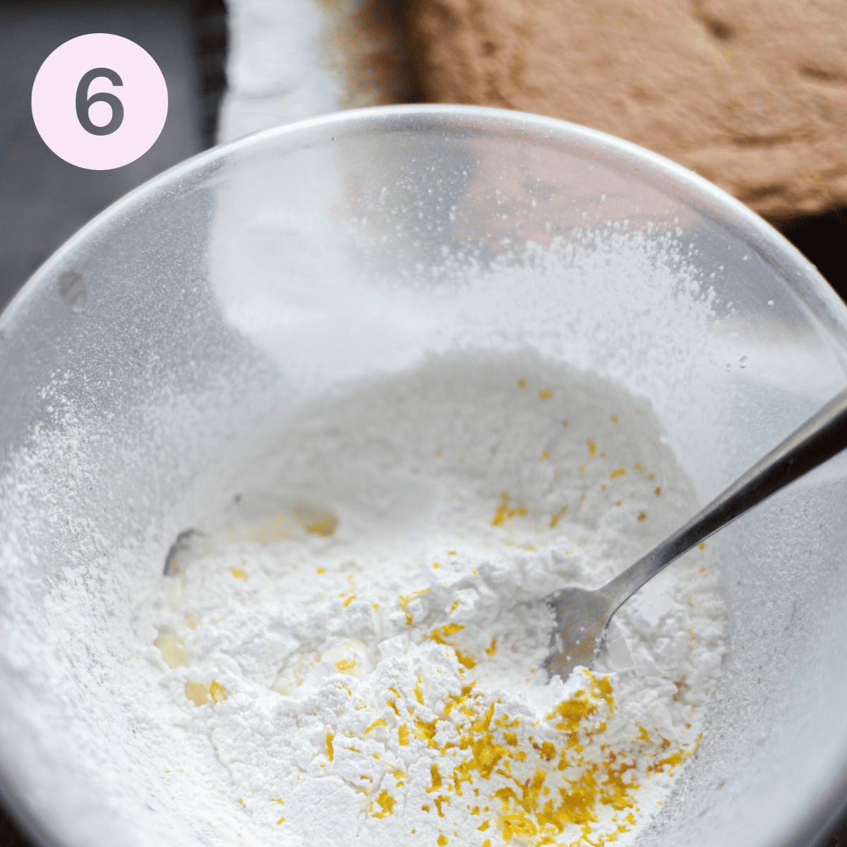 Whisking icing sugar and lemon to make icing.