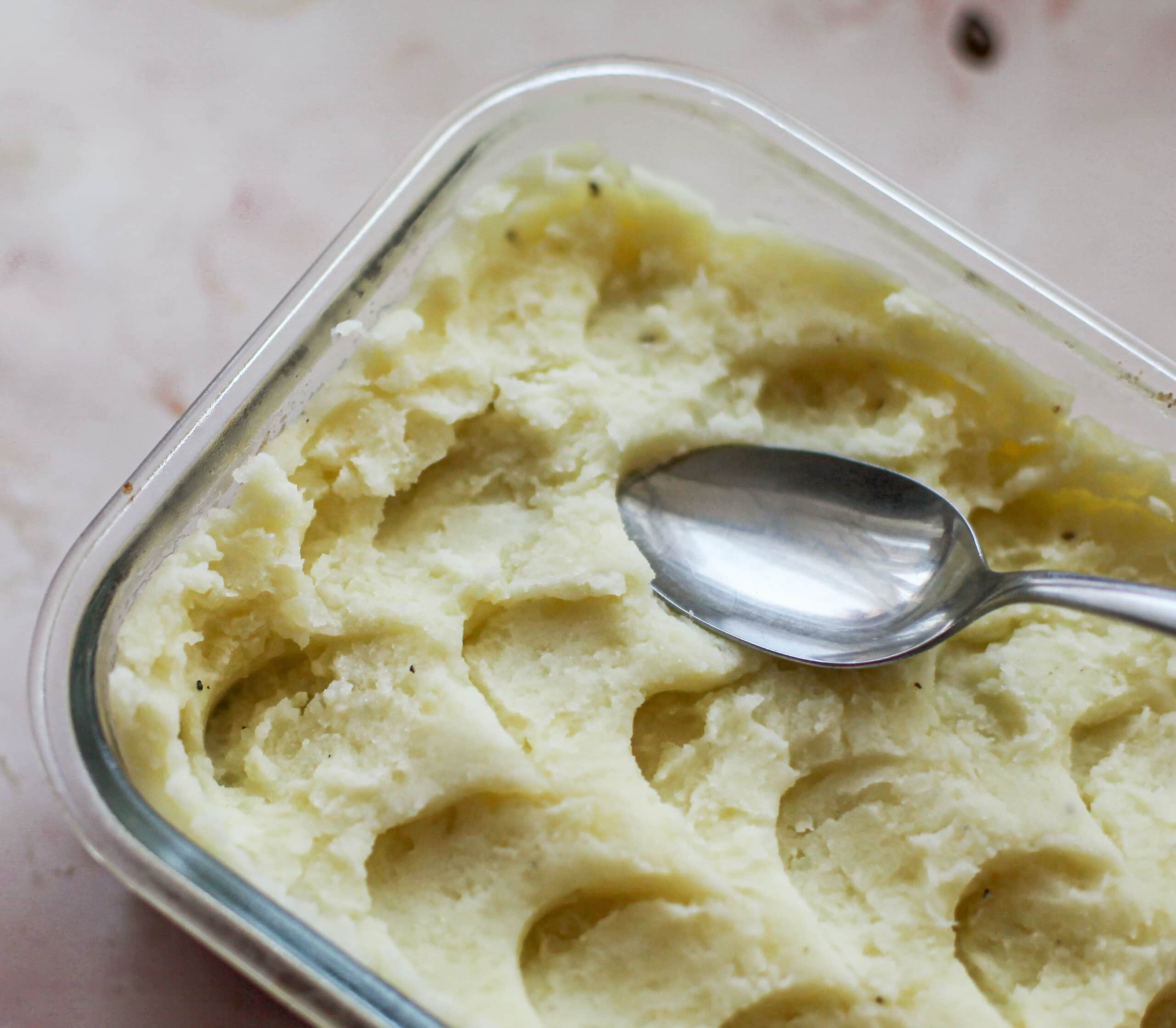 Scalloping mashed potatoes using the back of a spoon.