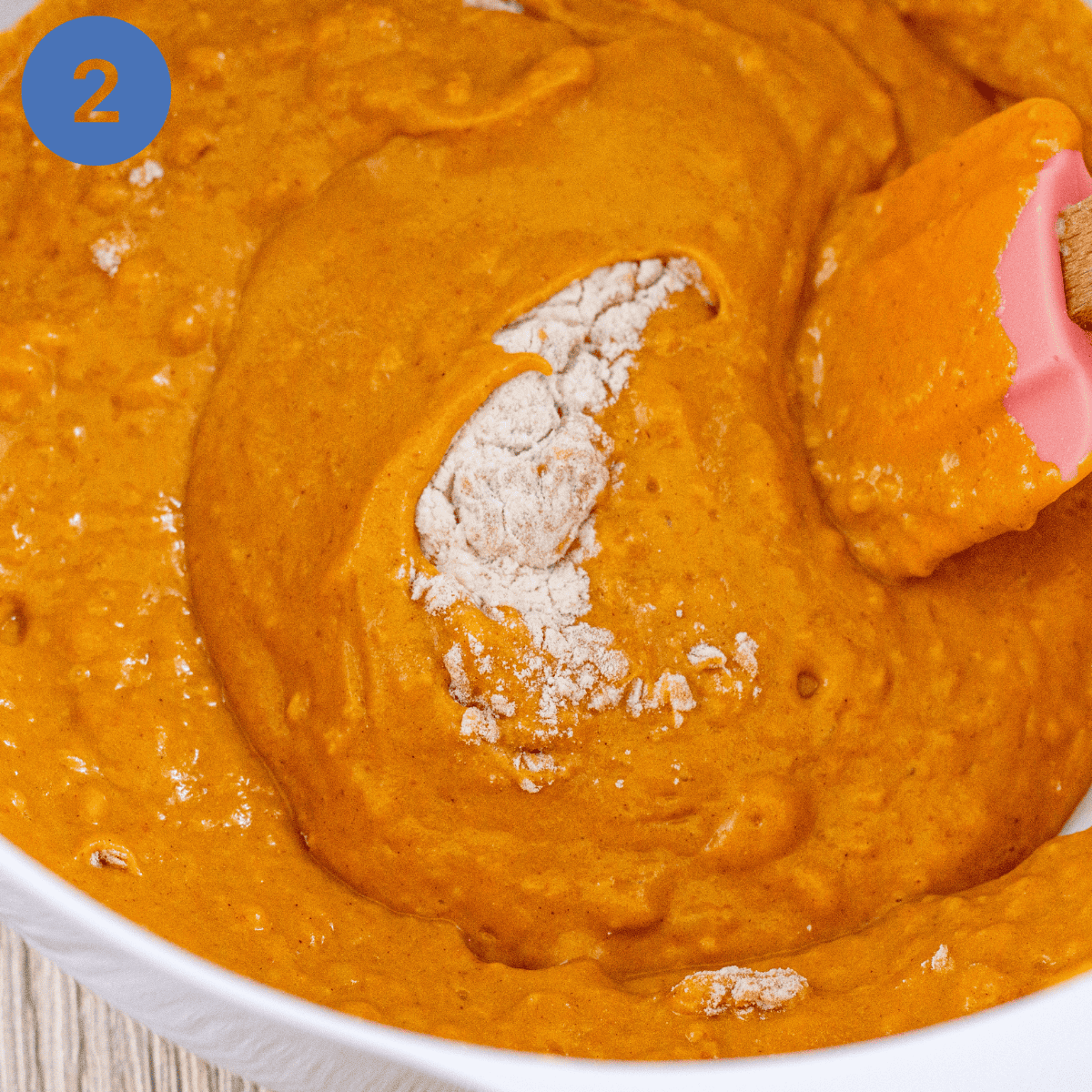 Adding the pumpkin mixture to the flour.