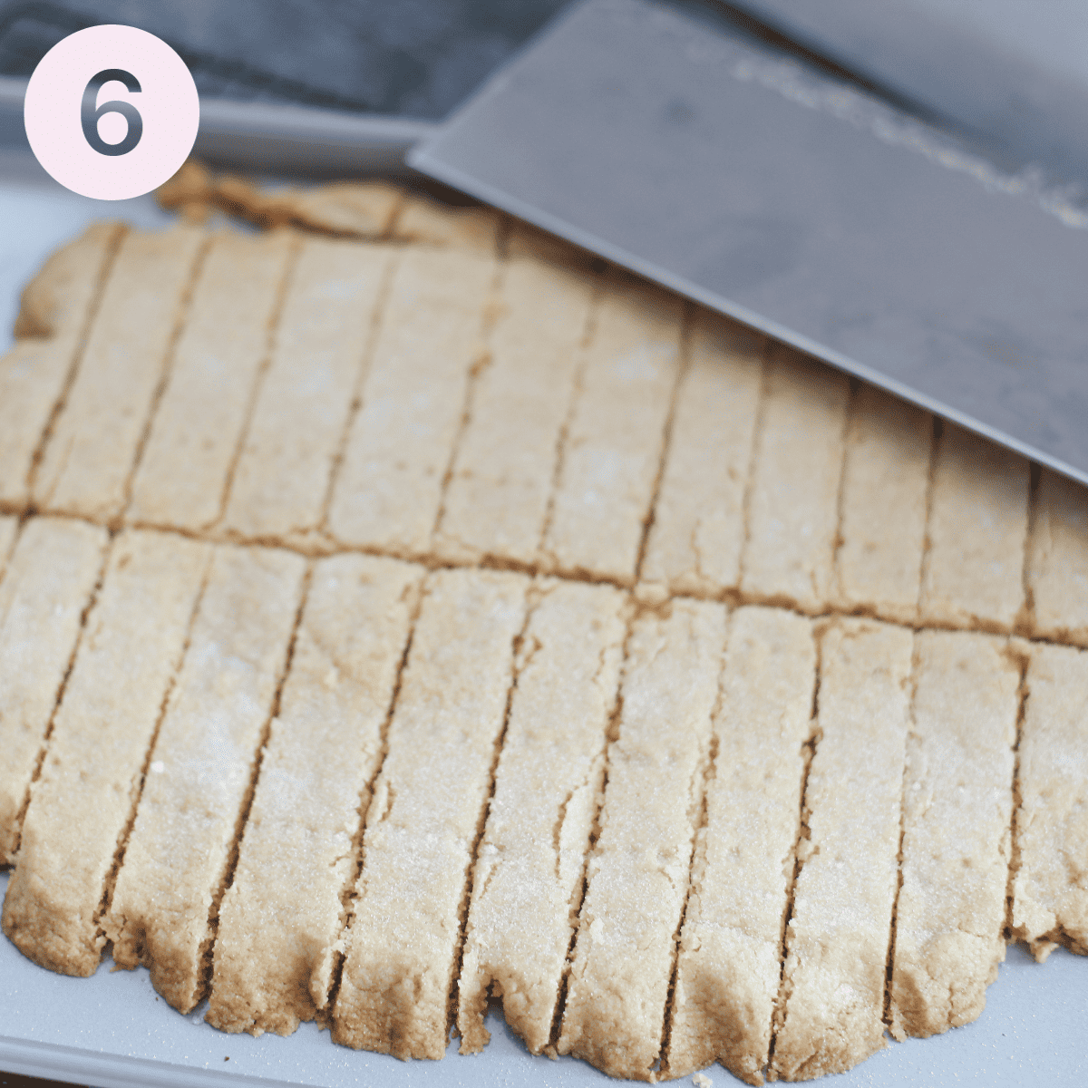 Cutting shortbread into fingers.
