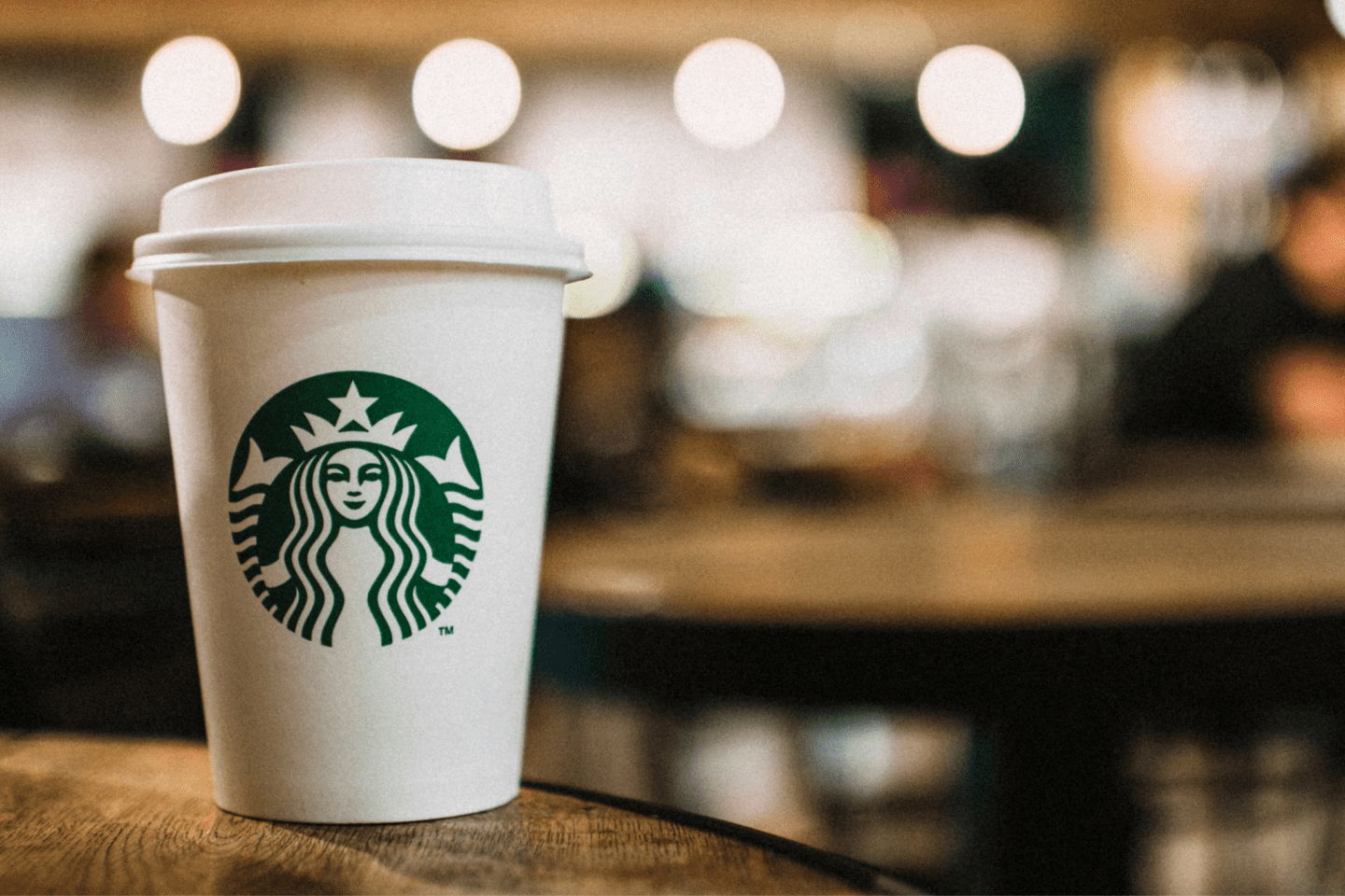 A Starbucks Cup on a coffee table