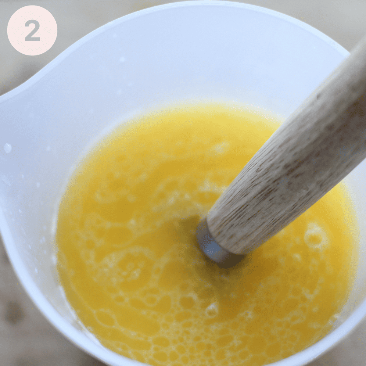 Adding melted butter to soured milk.
