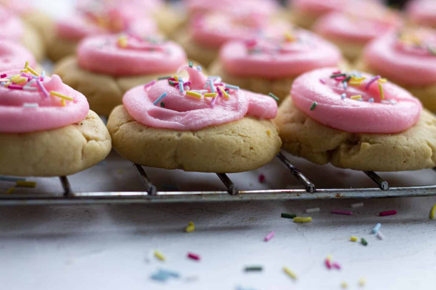 A tray of pink iced cookies