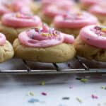 A tray of pink iced cookies