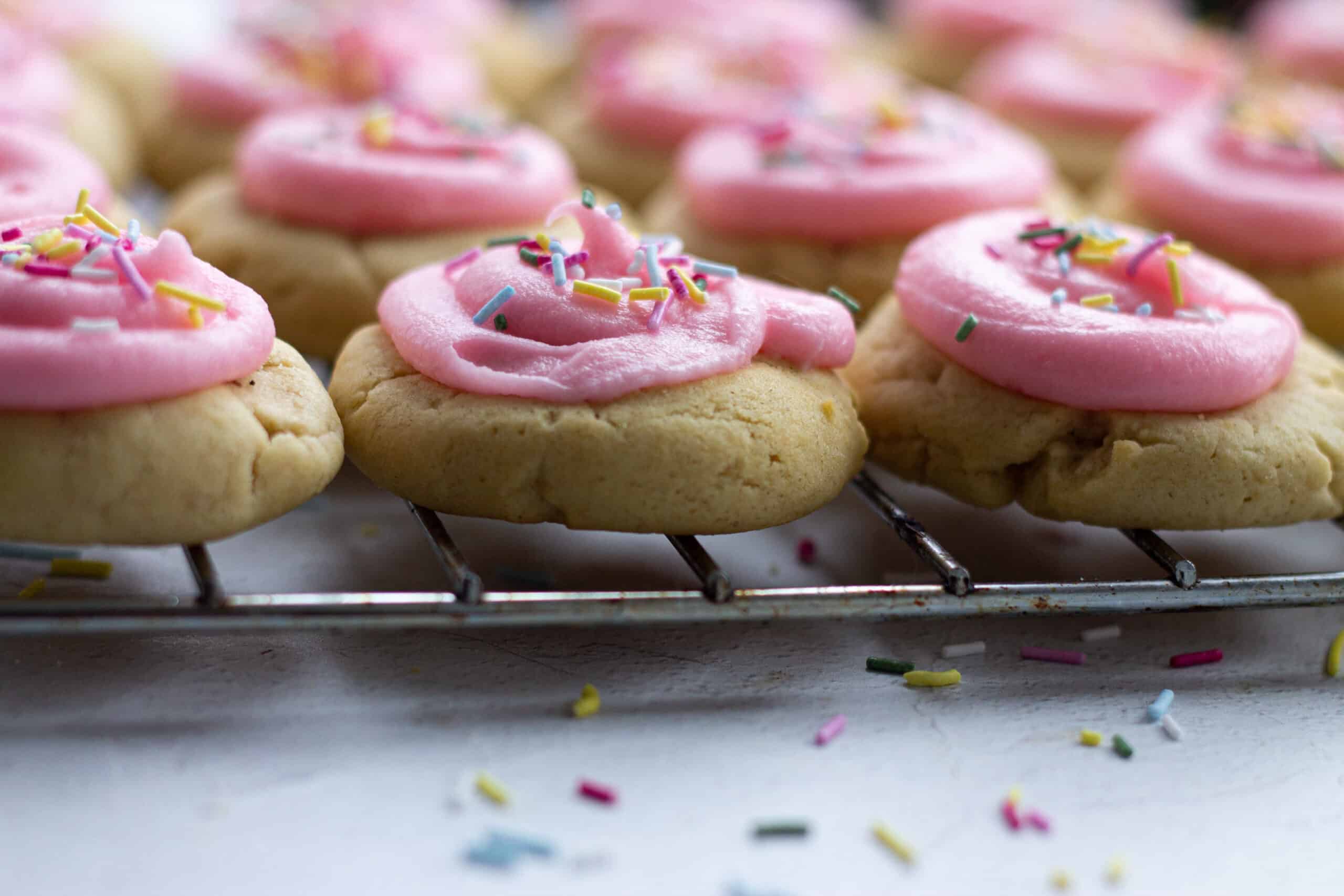 A tray of pink iced cookies