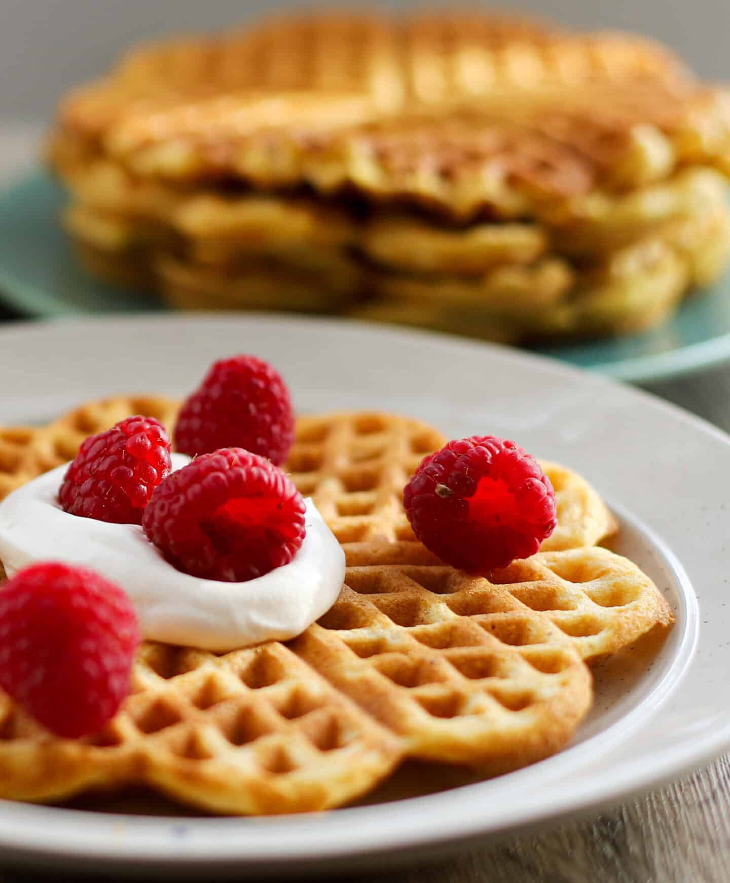 Cornmeal waffles with cream and raspberry