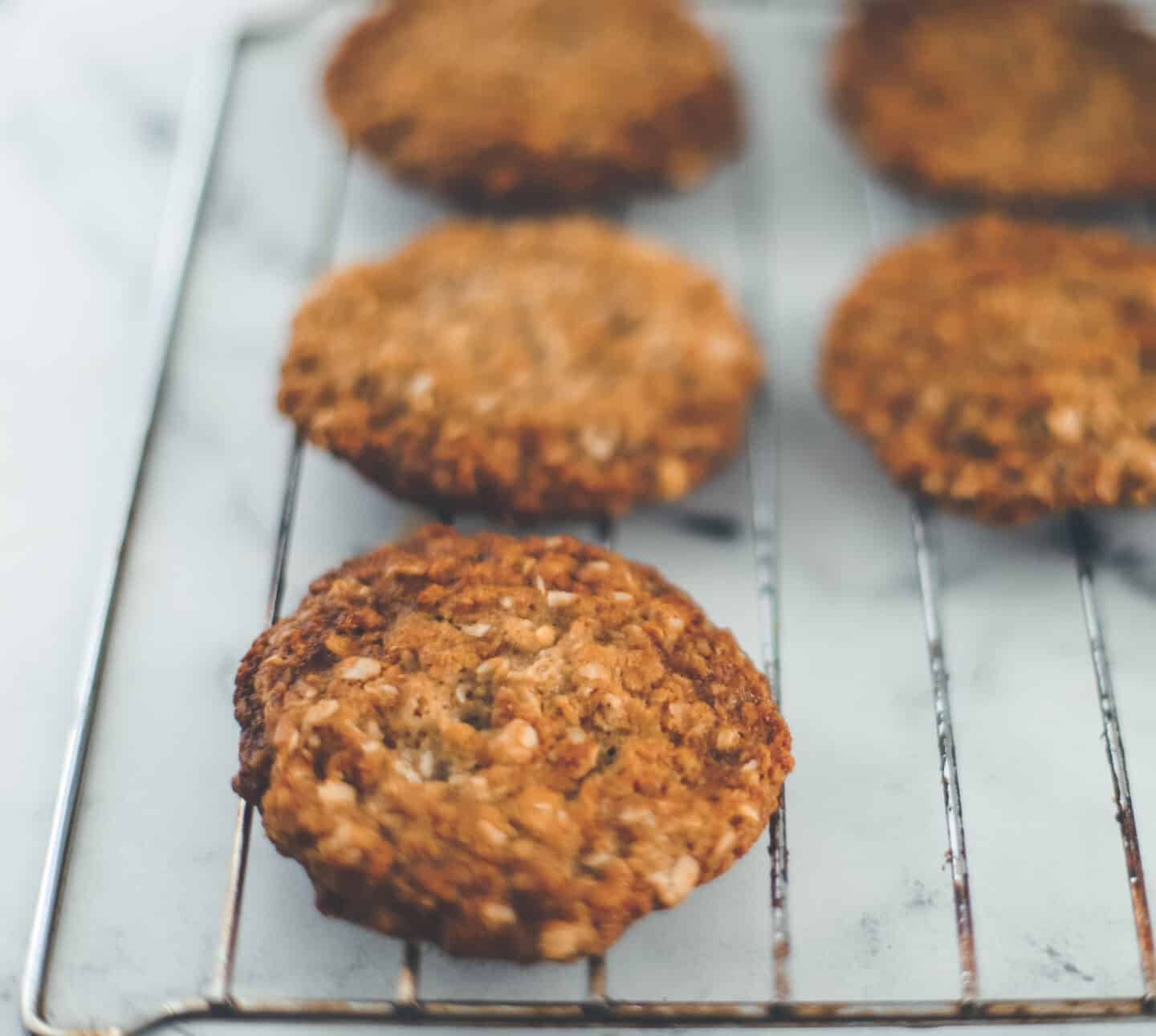 A layer of Anzac Cookies on a tray