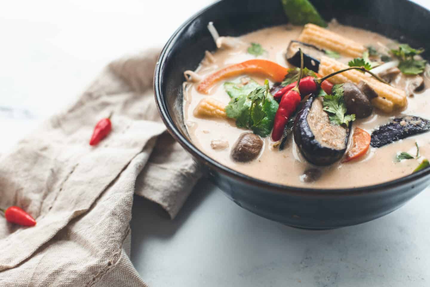 A bowl of thai green curry soup