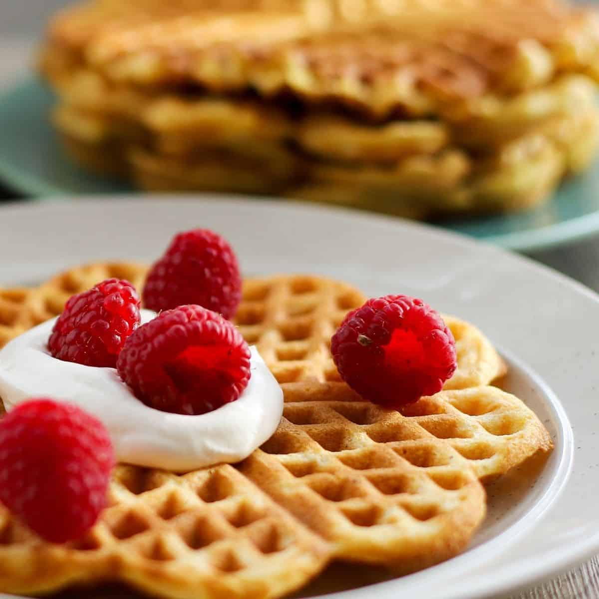 Cornmeal waffles with cream and raspberries