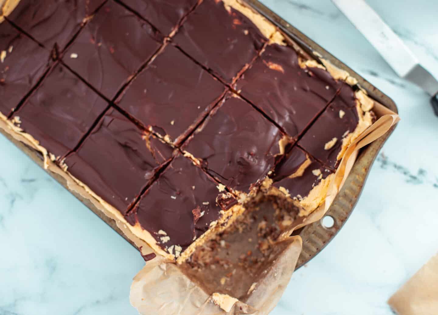 A tray of vegan nanaimo bars cut into squares