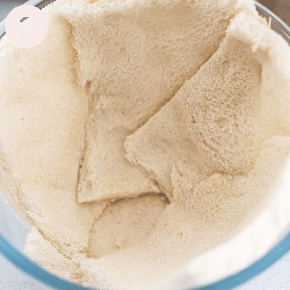 FInishing off layering bread in a pudding basin.