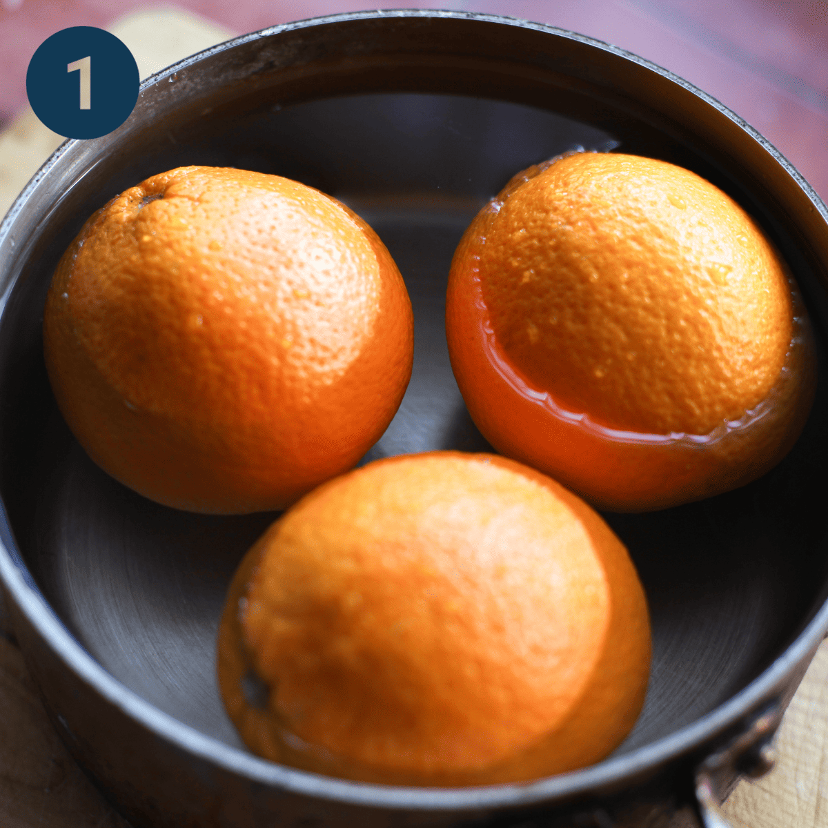 Boiling oranges for cake.