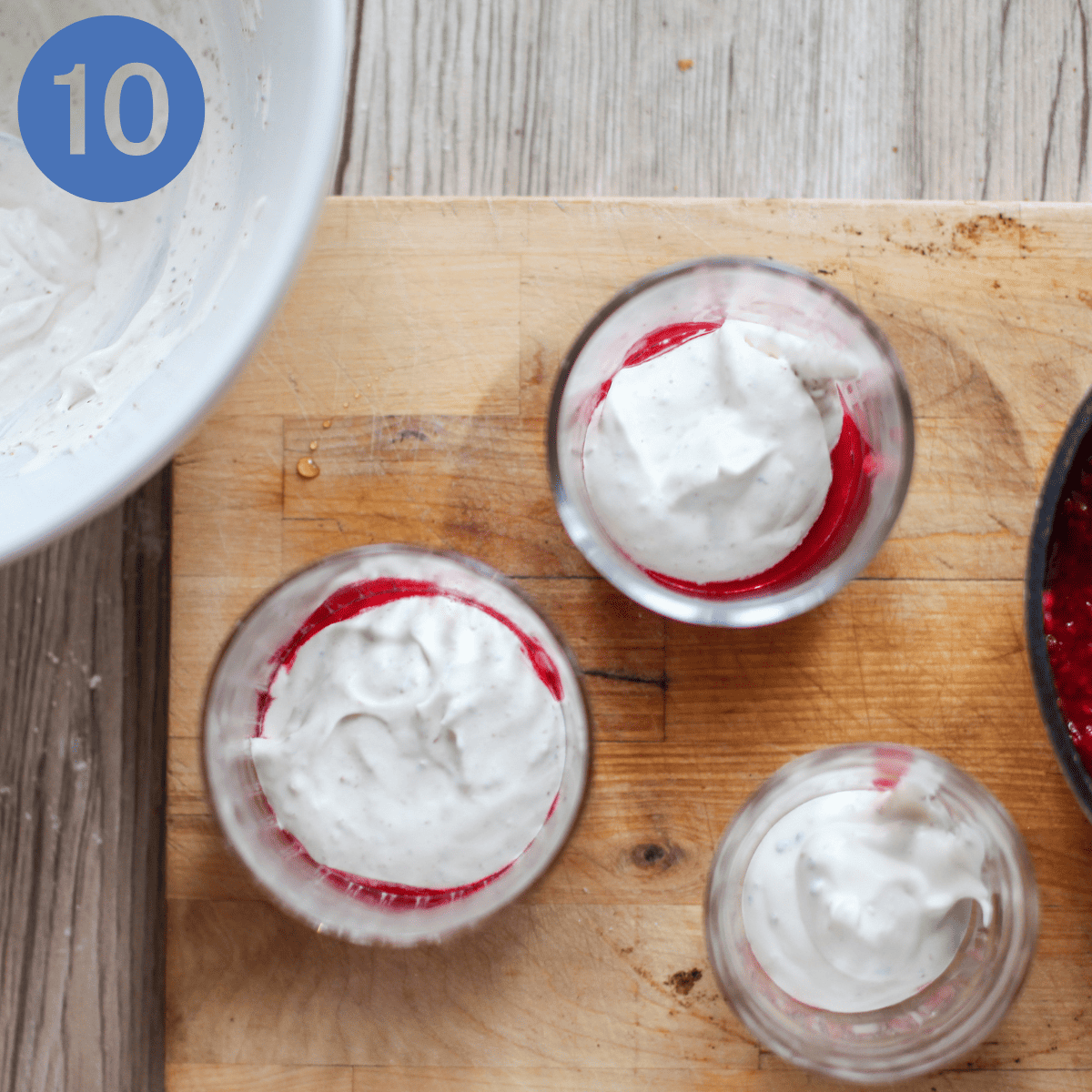 Layering up cranachan with whipped cream.