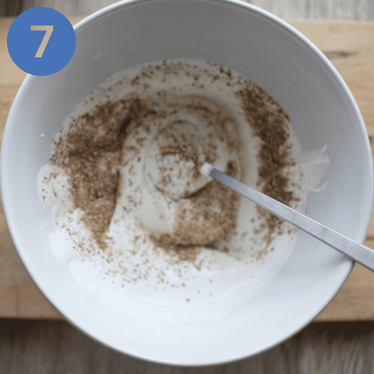 Stirring toasted oatmeal into whipped cream.