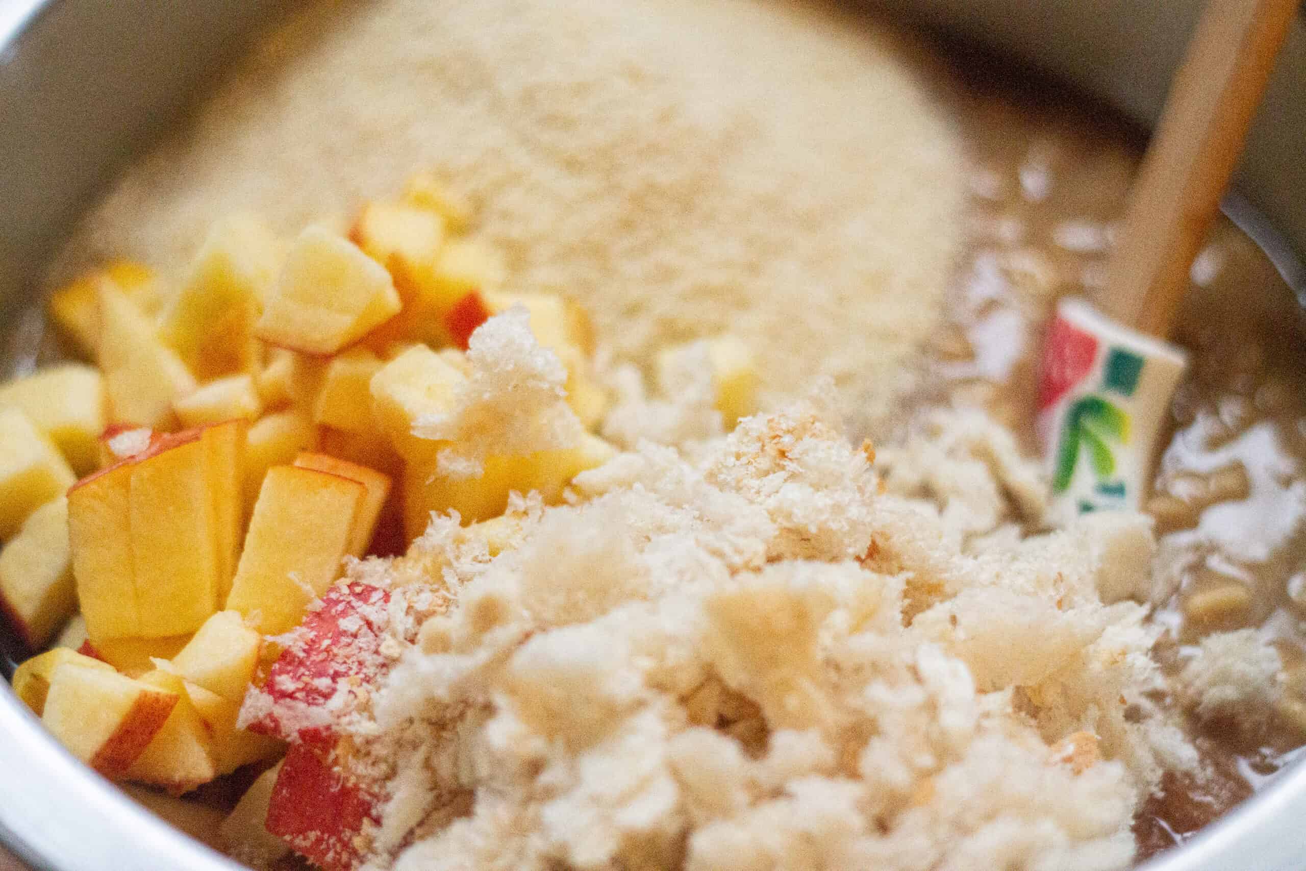 Adding breadcrumbs and apple to a suet mixture