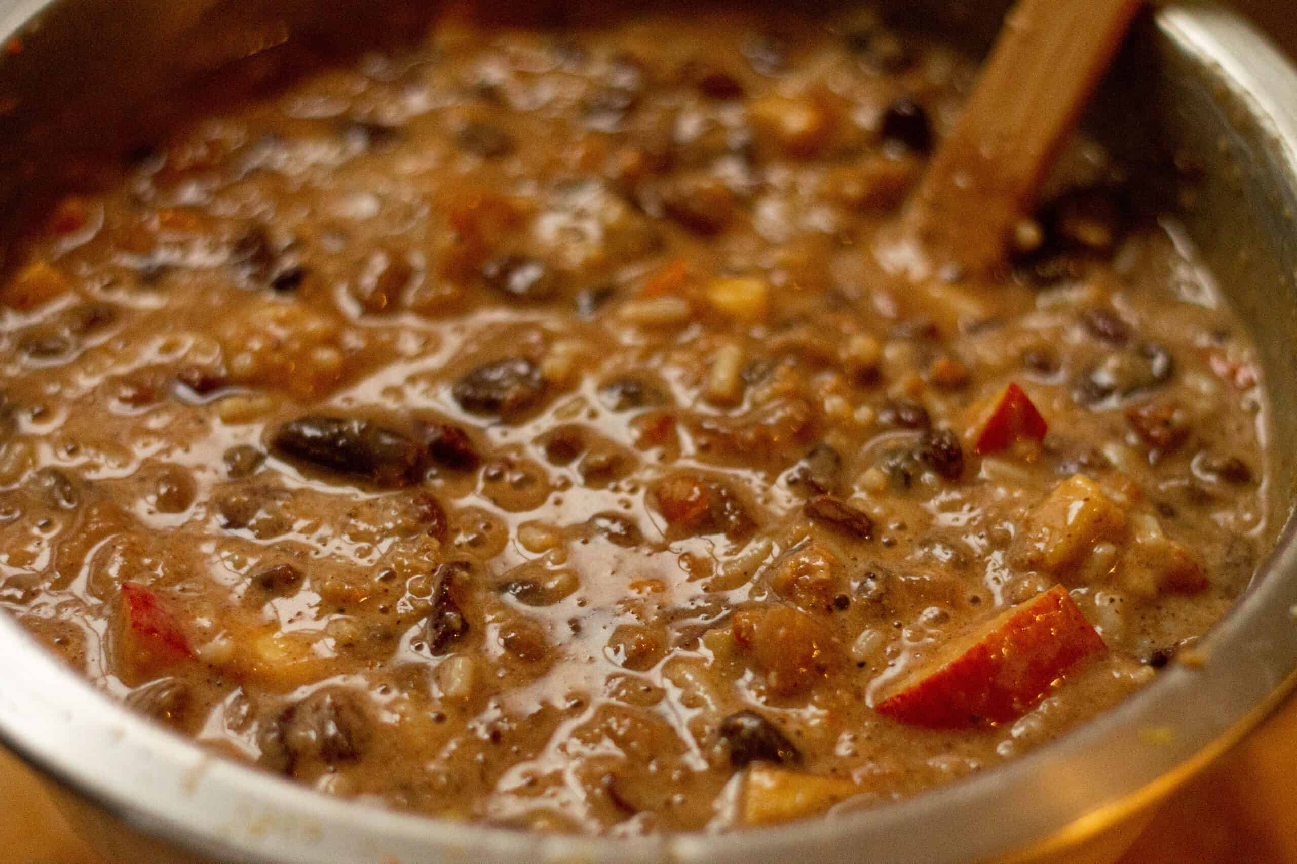 Adding the dried fruit to the xmas pudding mix