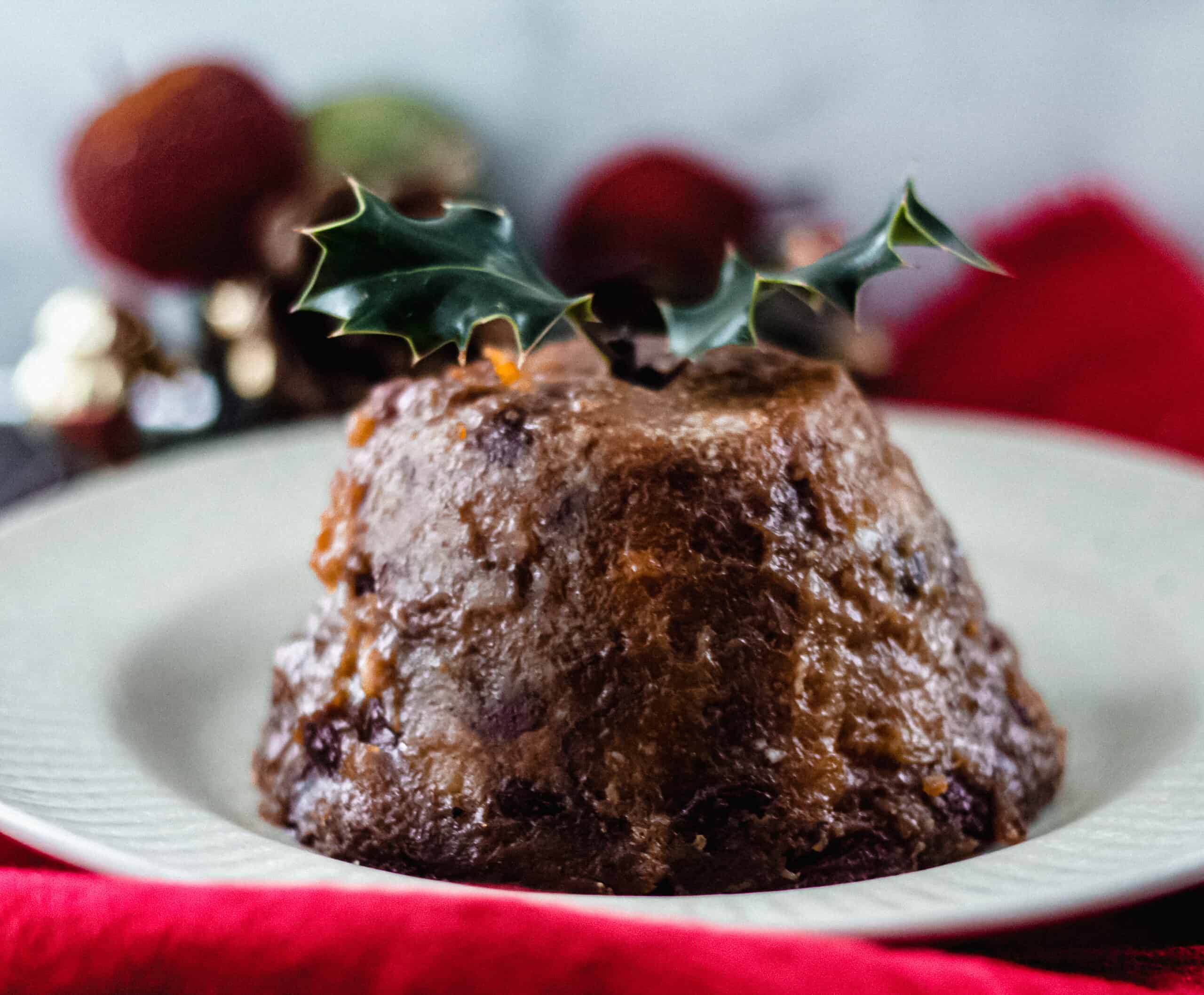 Christmas Pudding served on a plate with holly