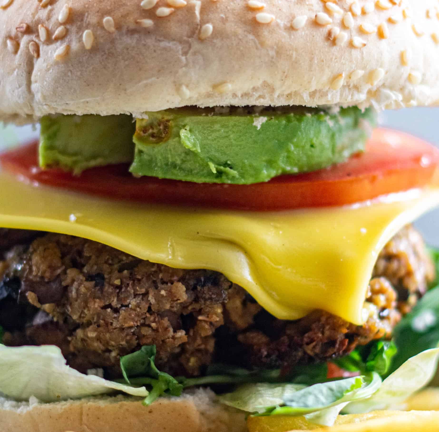 Easy Vegan Burger stacked with cheese and avocado