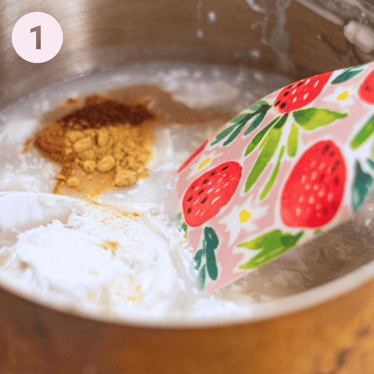 Simmering milk and spices in a pan.