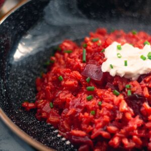 Beetroot Risotto in a black bowl