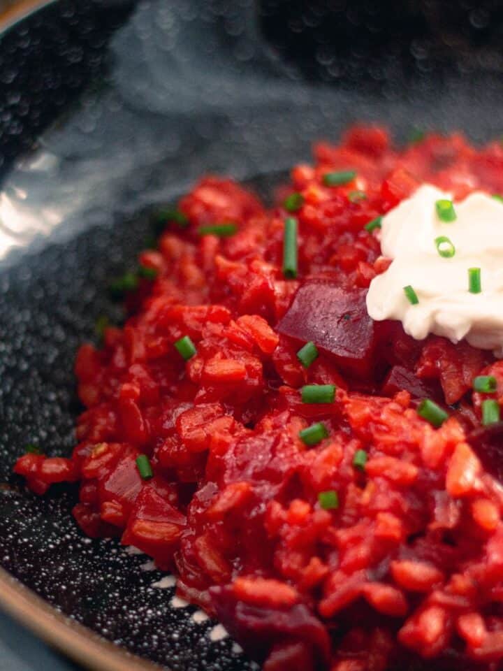 Beetroot Risotto in a black bowl