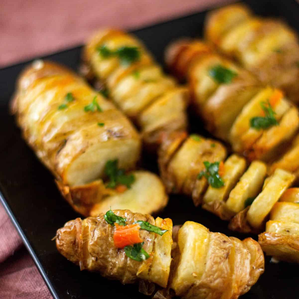 Hasselback Potatoes served with chopped herbs