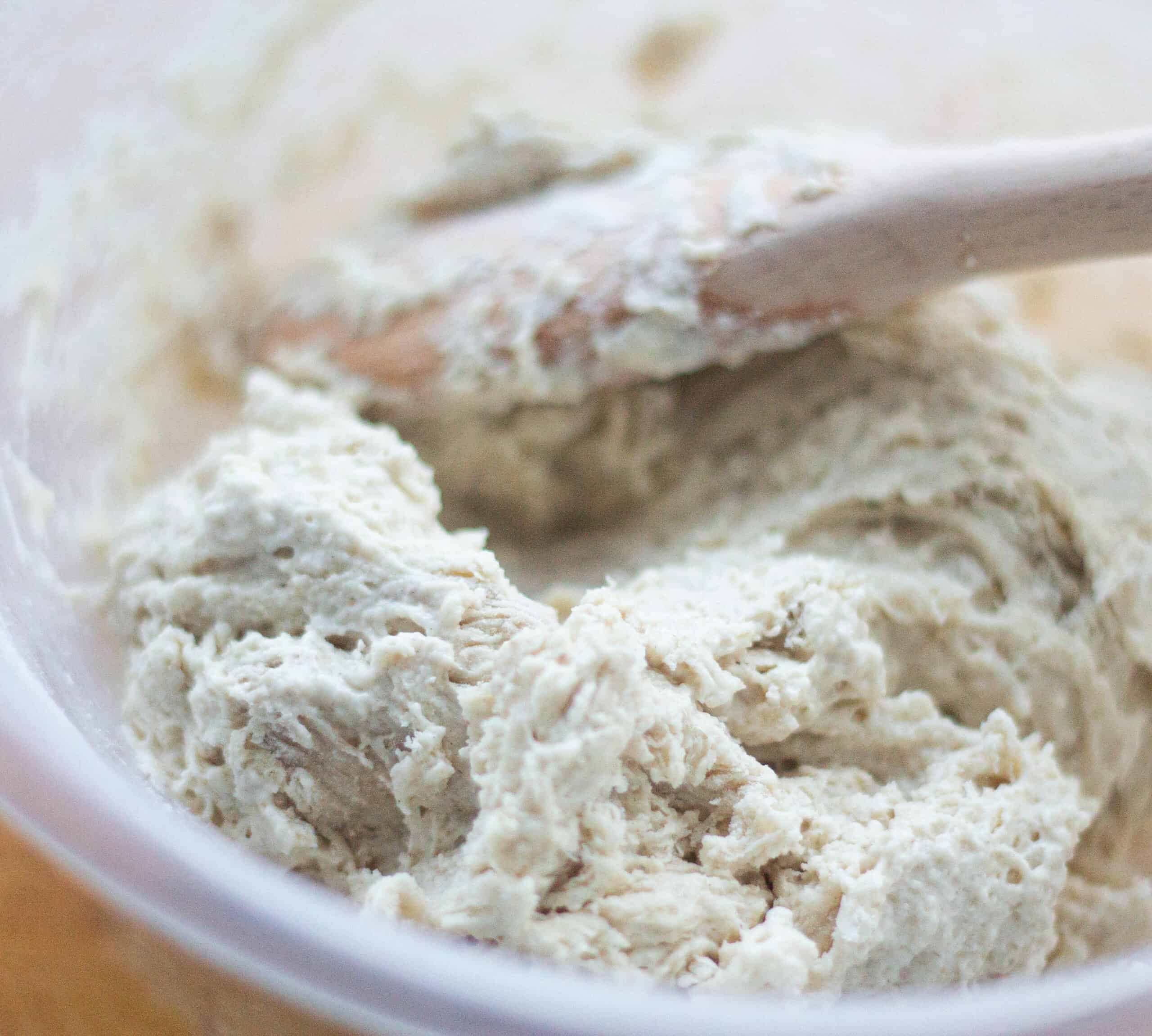 Mixing flour water and yeast until you have a rough dough