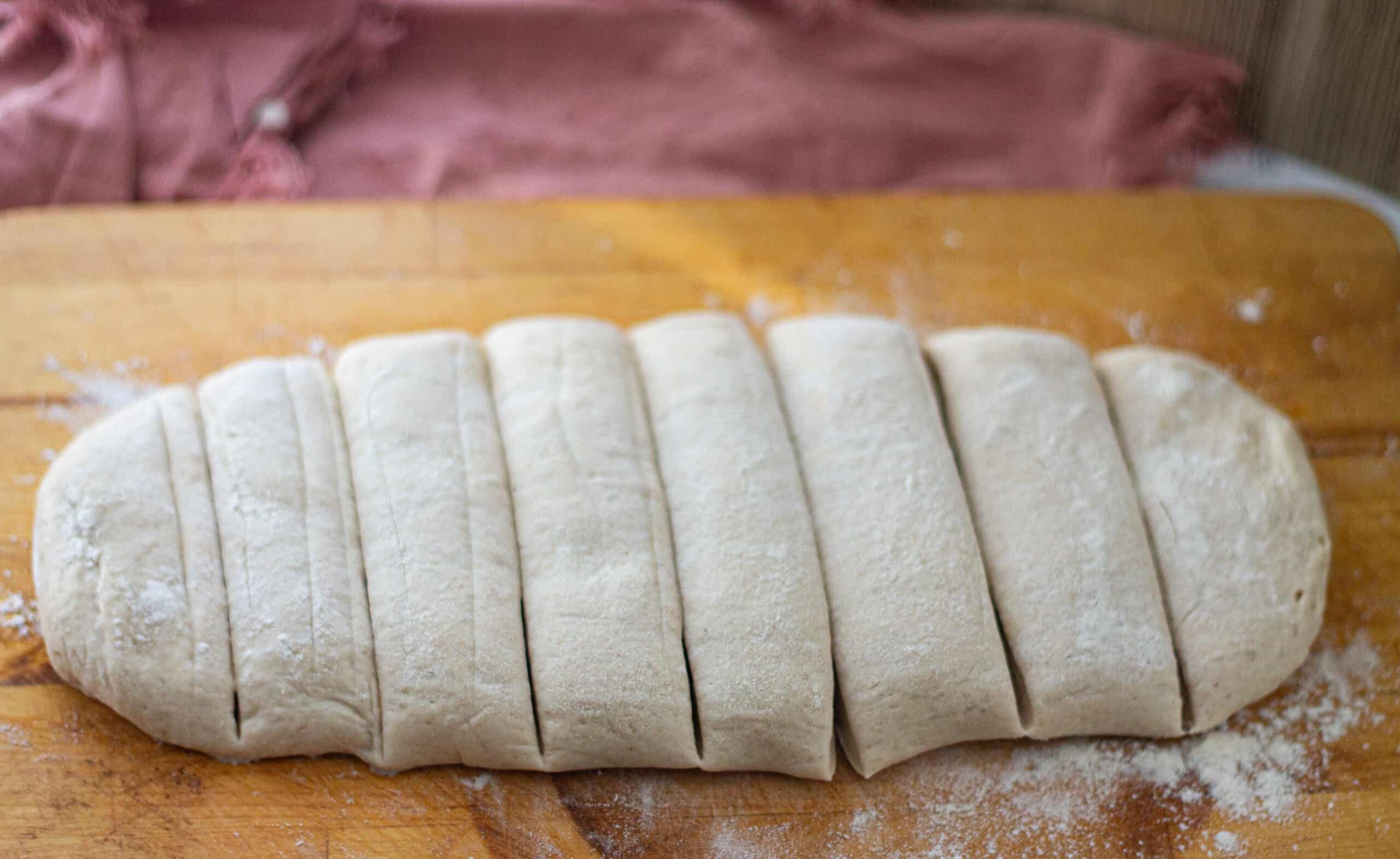 Cutting the bagel dough into sections