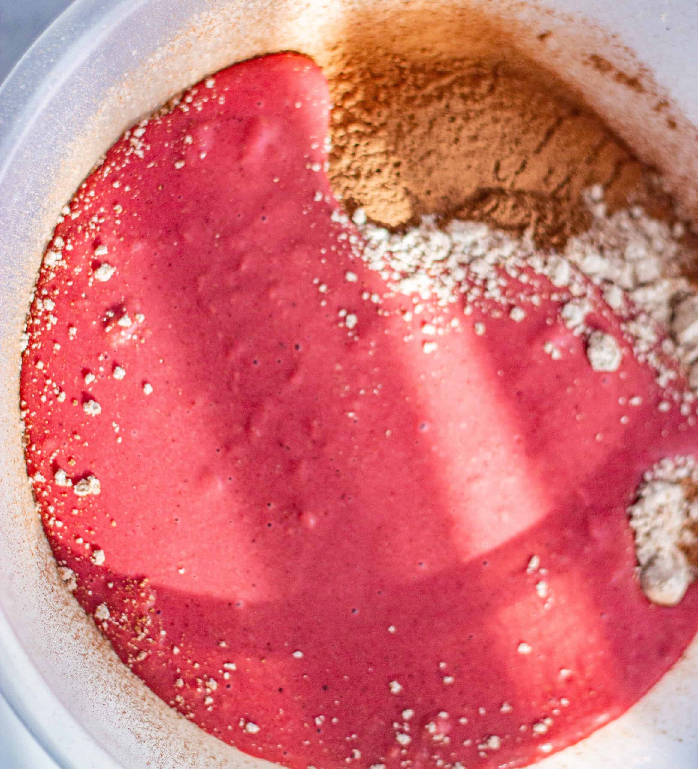 Mixing the blended beetroot into sifted ingredients