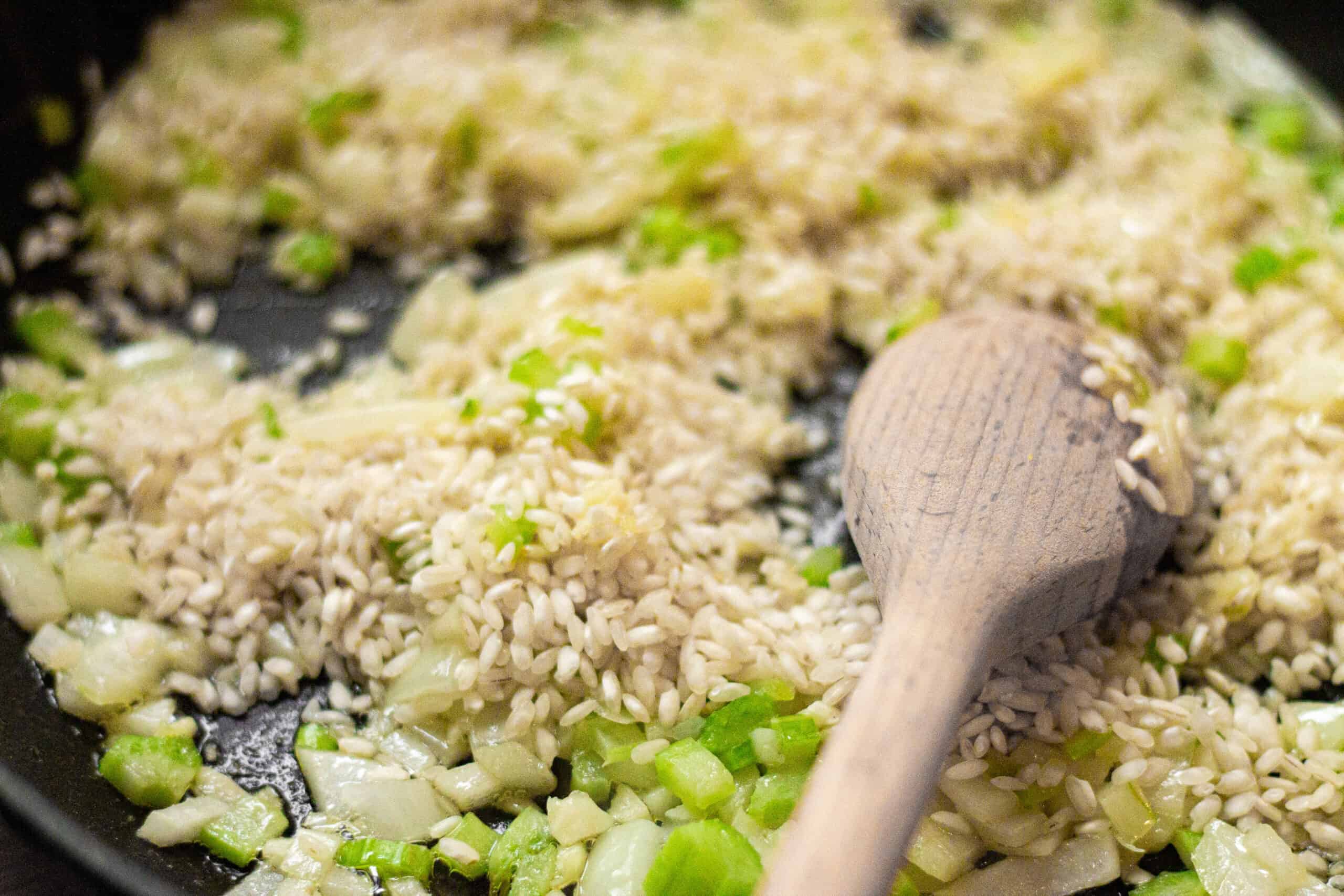 Adding rice to sauteed onion and garlic