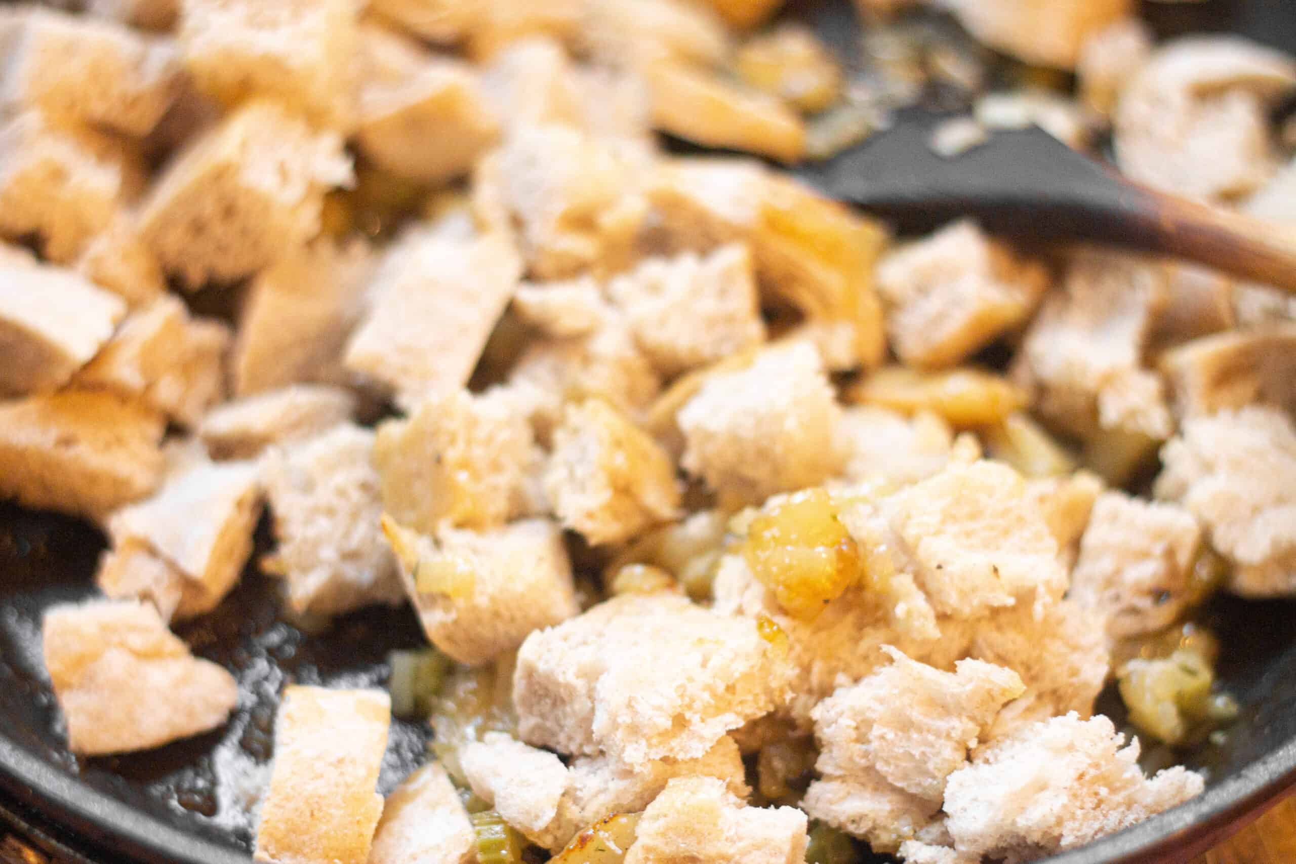 Adding the bread to the bread stuffing