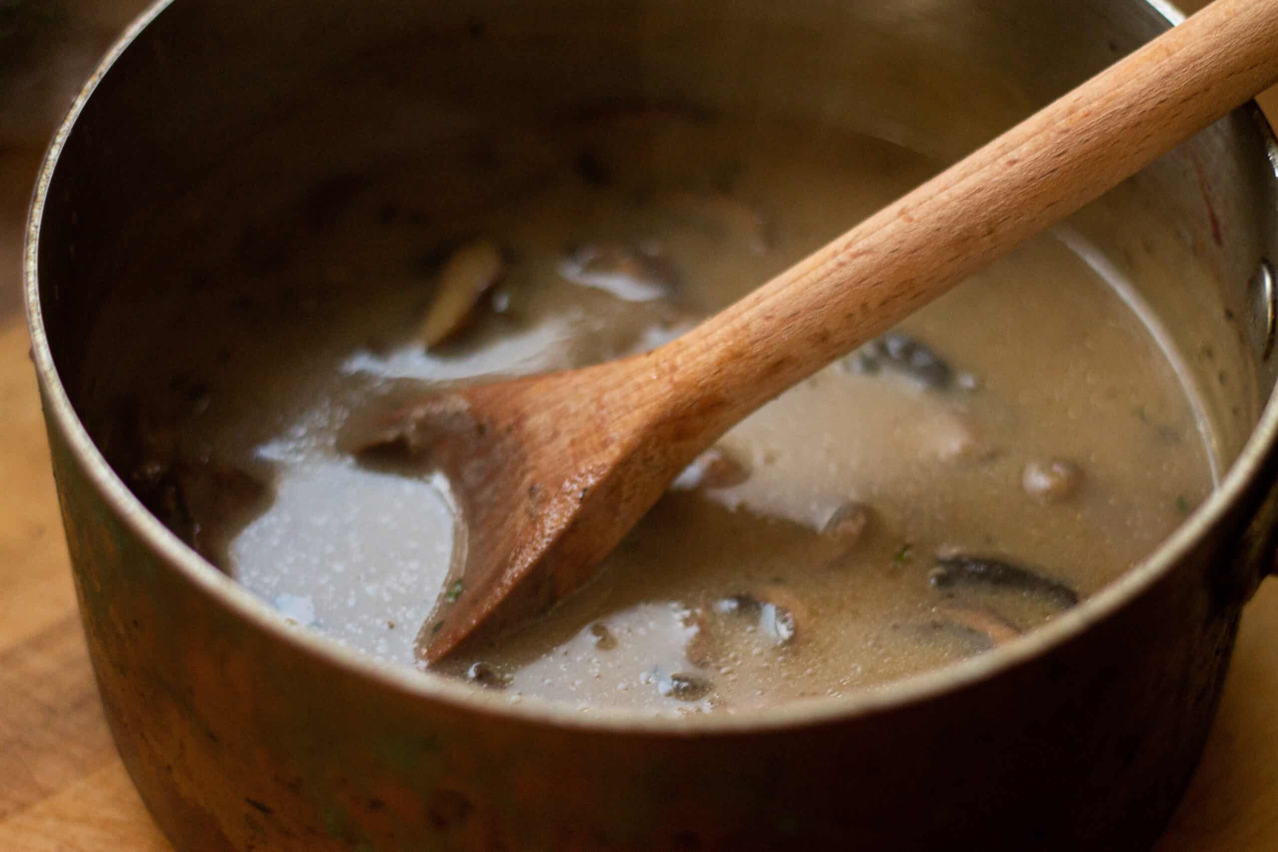 Stirring mushrooms into soup