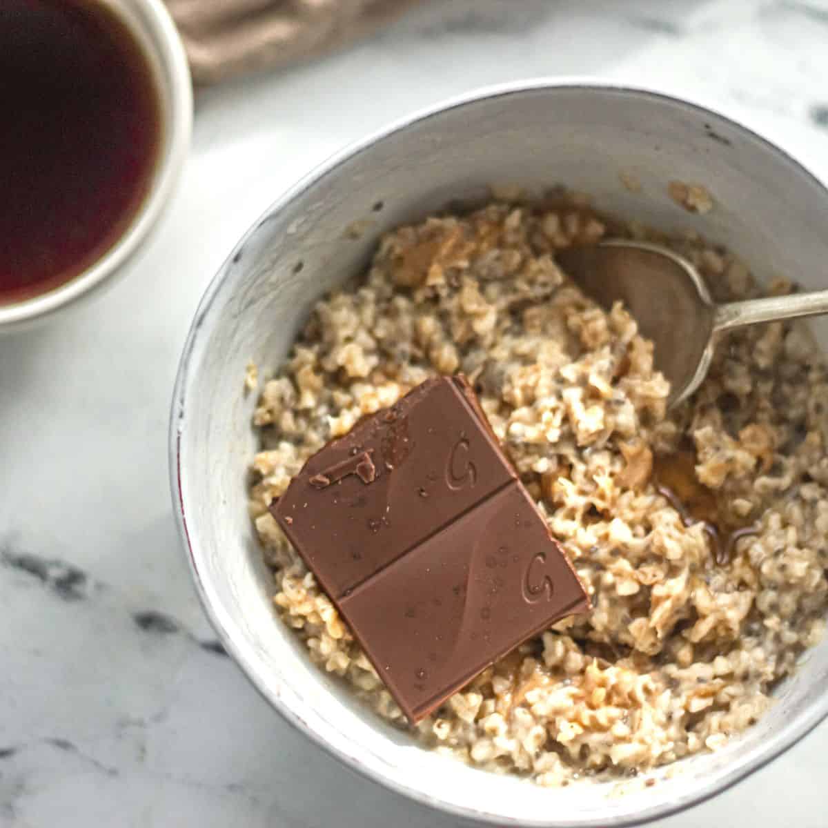 Oatmeal Bowl with chocolate and cup of coffee