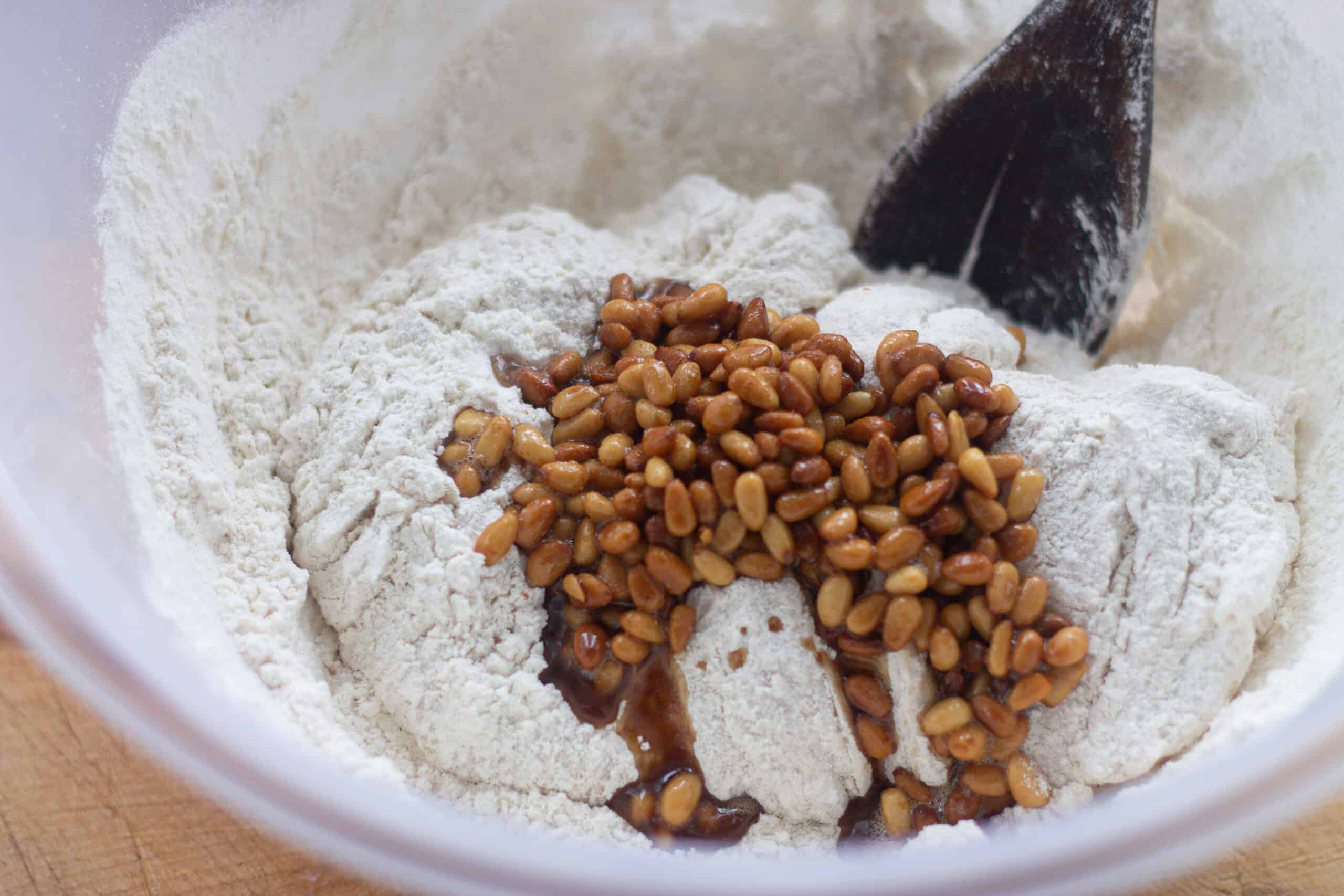 Adding pine nuts to polenta dough