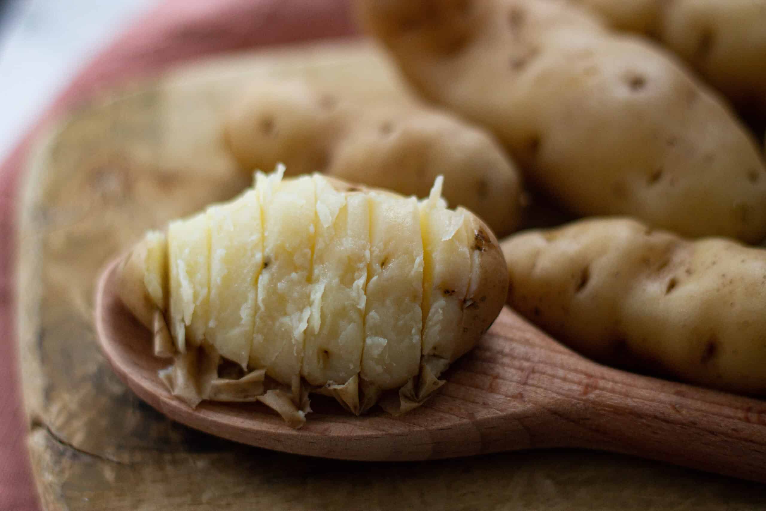 Hasselback potato being sliced