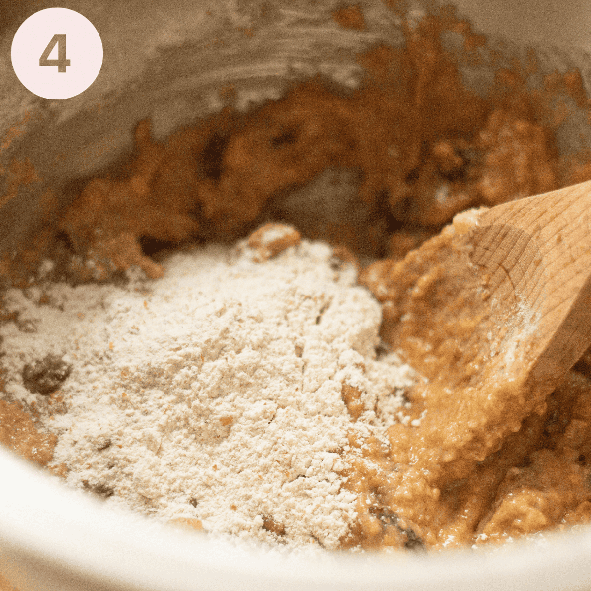 Adding flour to cake batter.