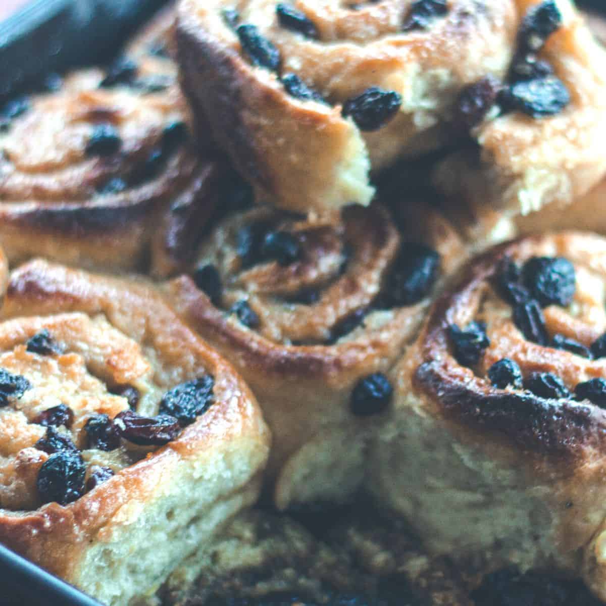 A pan full of baked chelsea buns