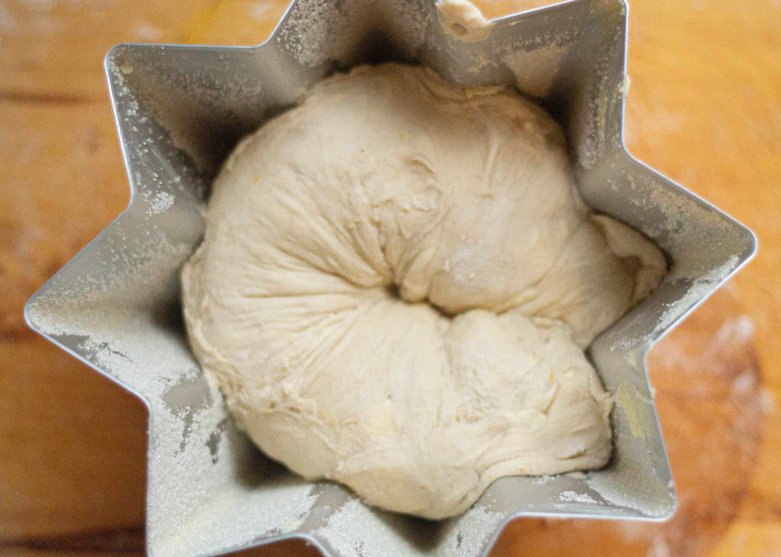 Placing the swiss roll dough into the pandoro tin