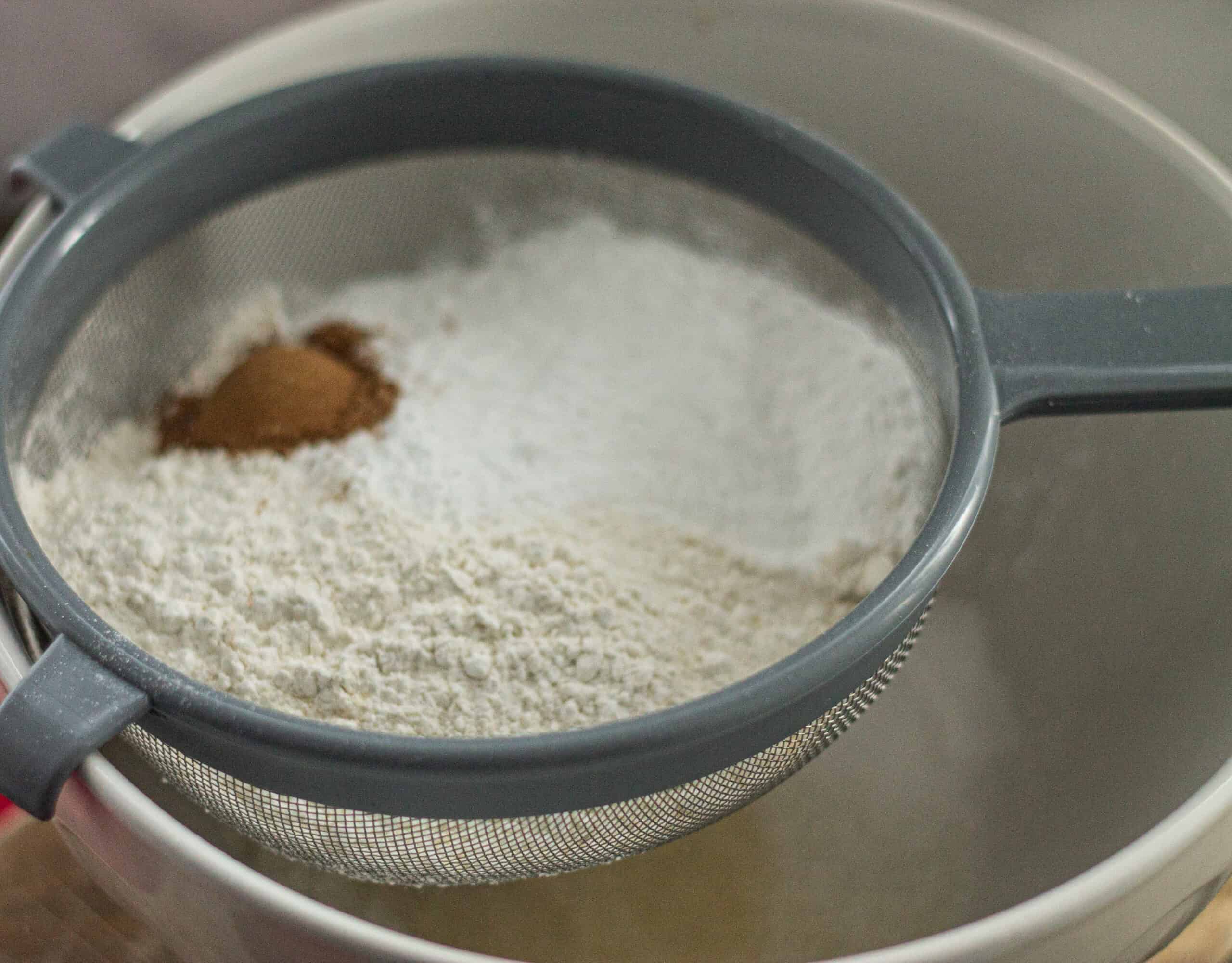 Sifting ingredients into a bowl