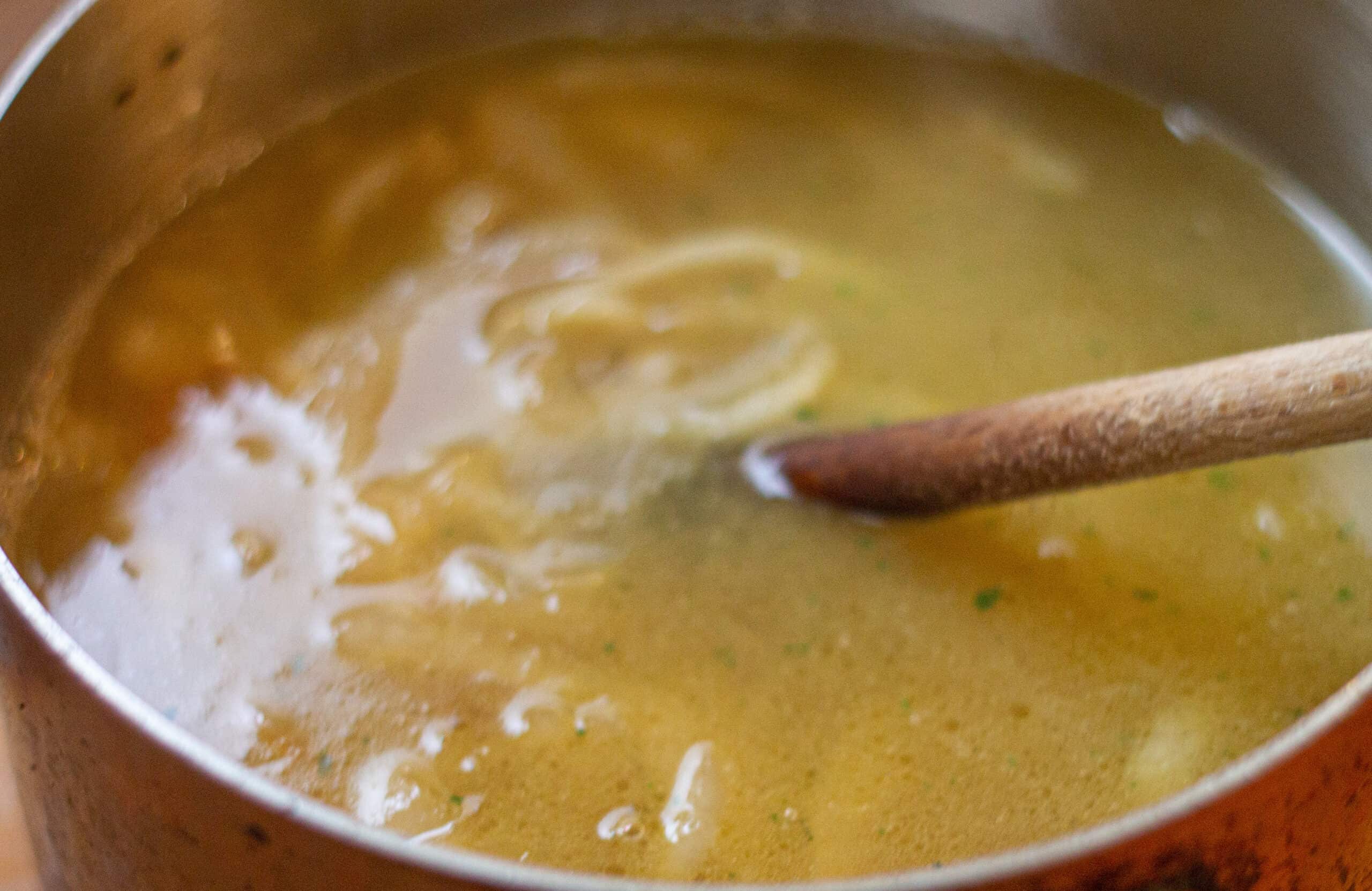 Adding stock to onion soup